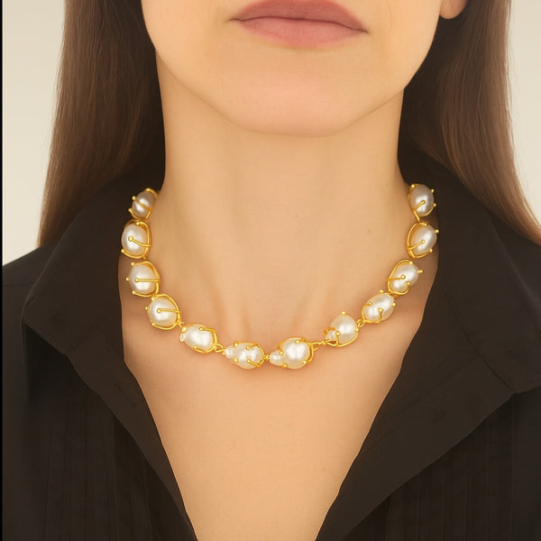 Pearl necklace worn by a person against a neutral background