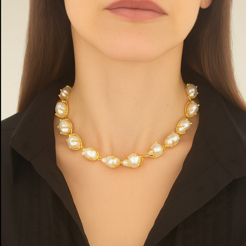Pearl necklace worn by a person against a neutral background